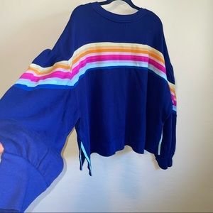 CABANA. navy sweater with rainbow design on the back.